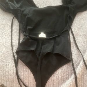 Black body suit with puff sleeves and tie open back